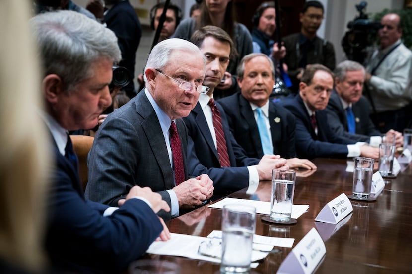 U.S. Attorney General Jeff Sessions (second from left) and Texas Attorney General Ken Paxton...