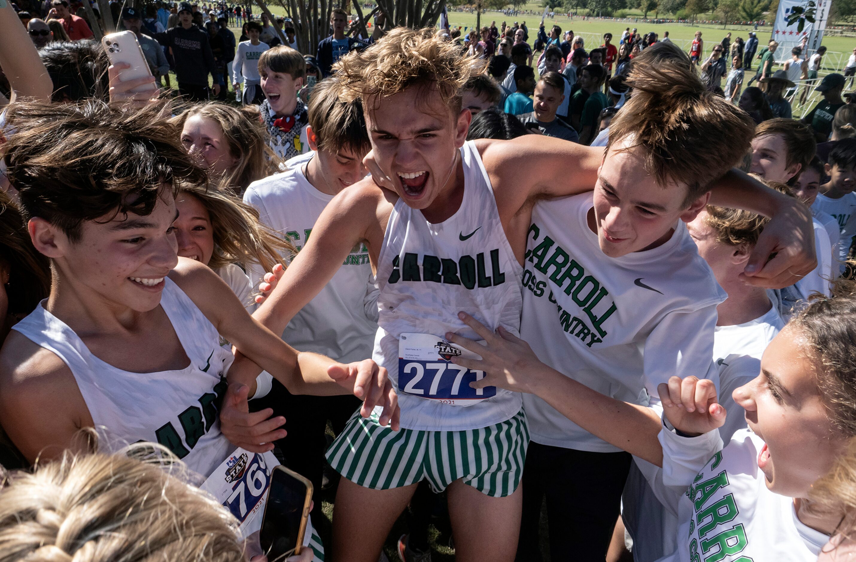 Southlake Carroll David Fisher, (2771), center, and teammate, Jude Alvarez, (2769), left,...