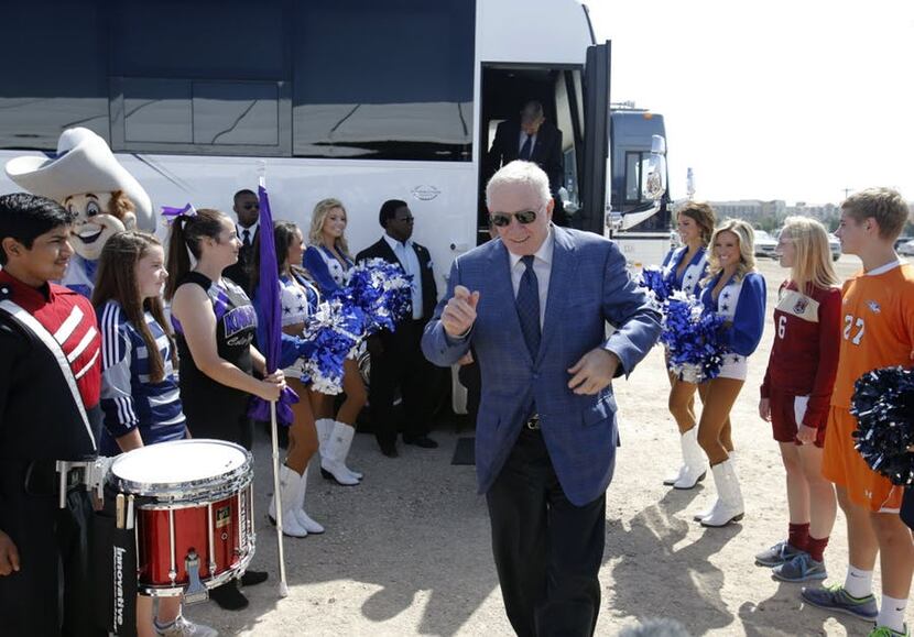 Dallas Cowboys owner and general manager Jerry Jones makes his way out of the bus in between...
