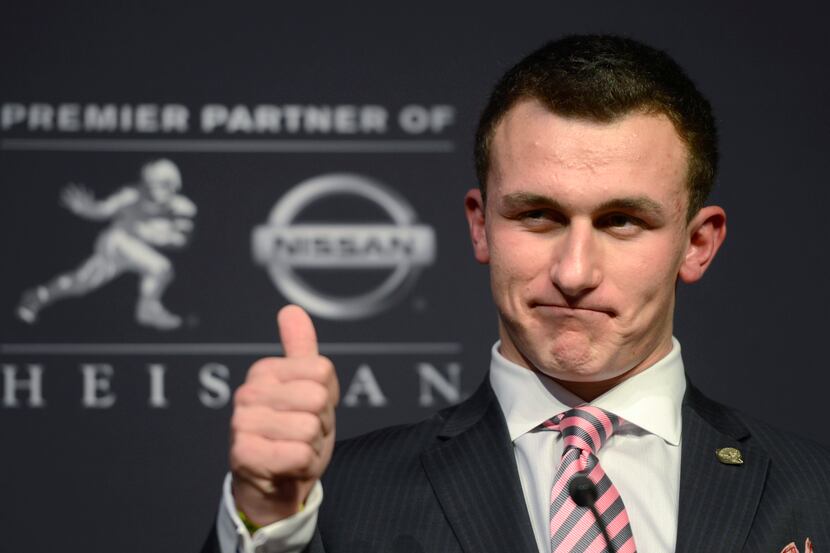 FILE - This Dec. 8, 2012 file photo shows Texas A&M quarterback Johnny Manziel gesturing as...