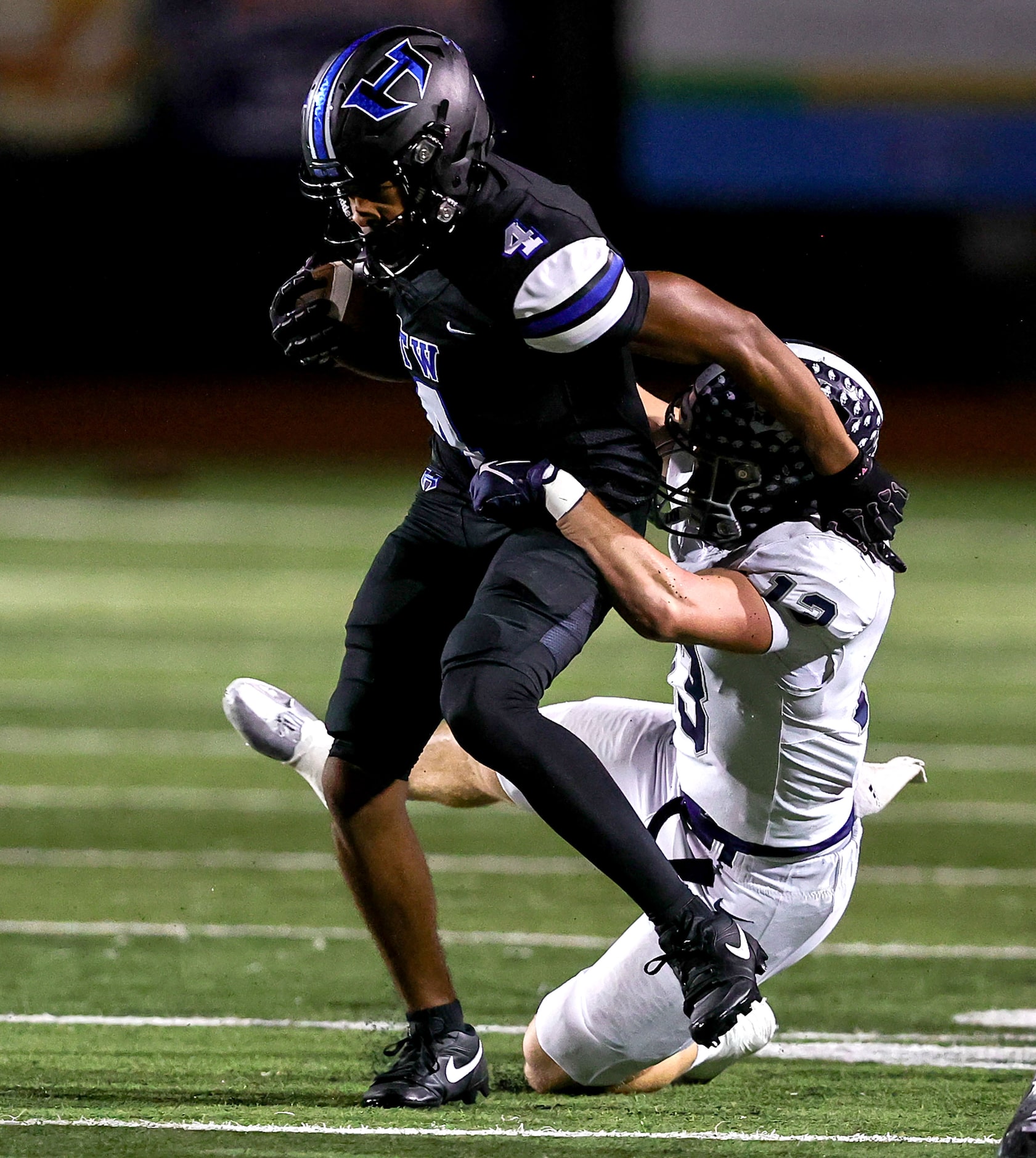 Hebron wide receiver Sheldon Armour (4) tries to avoid Flower Mound safety Silas Wilson (13)...