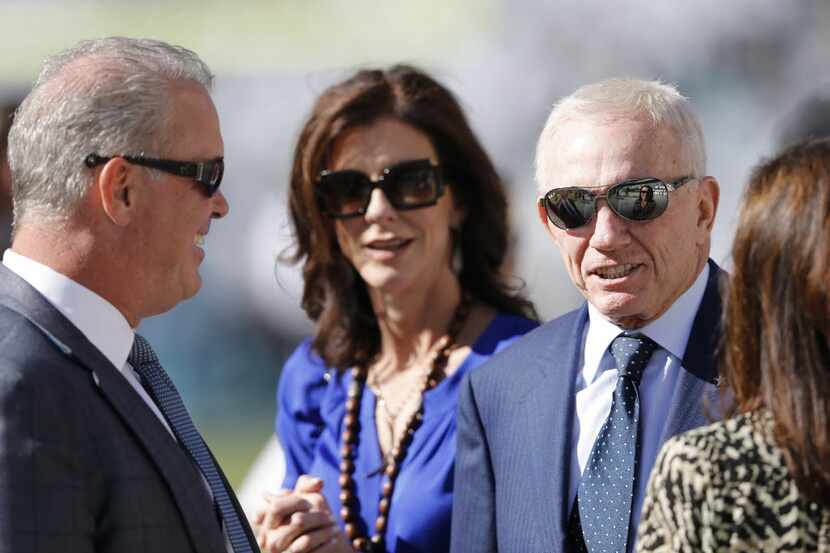 Dallas Cowboys owner Jerry Jones on the sidelines with son Stephen Jones and family before a...