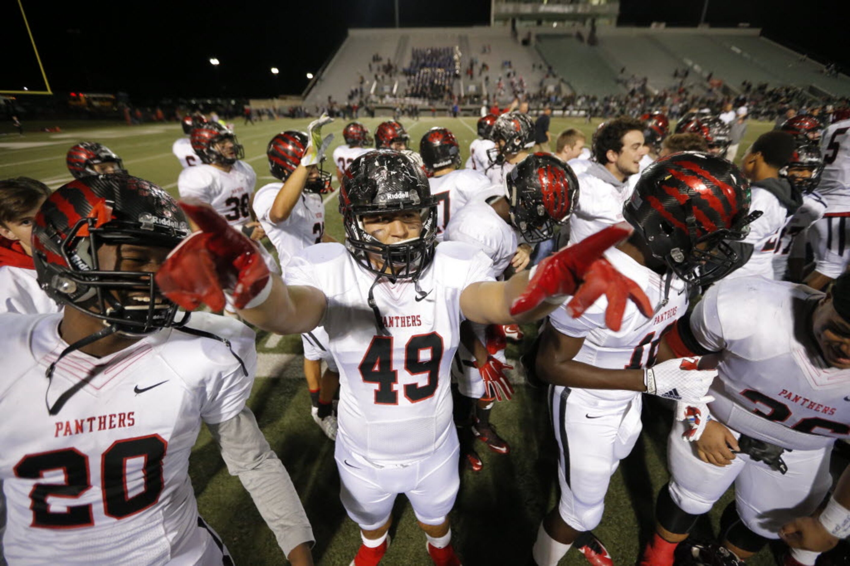 Colleyville Heritage sophomore wide receiver Ke'von Ahmad (20) and senior linebacker Logan...