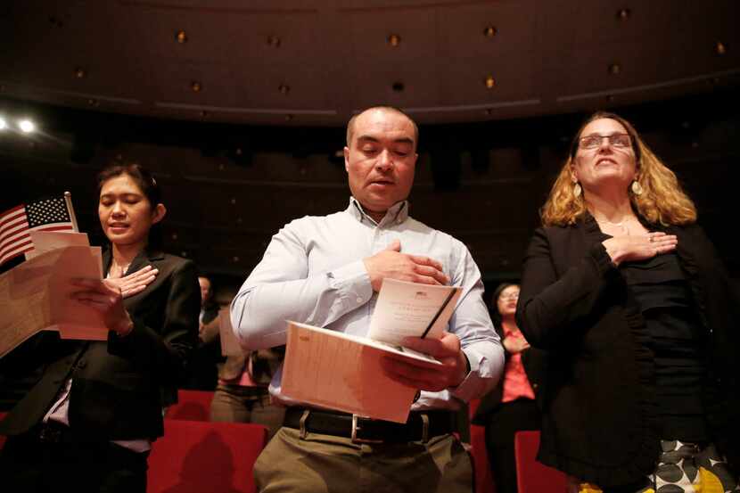 New U.S. citizens (from left) Supinya Phapant of Thailand, Julio Martinez of El Salvador and...