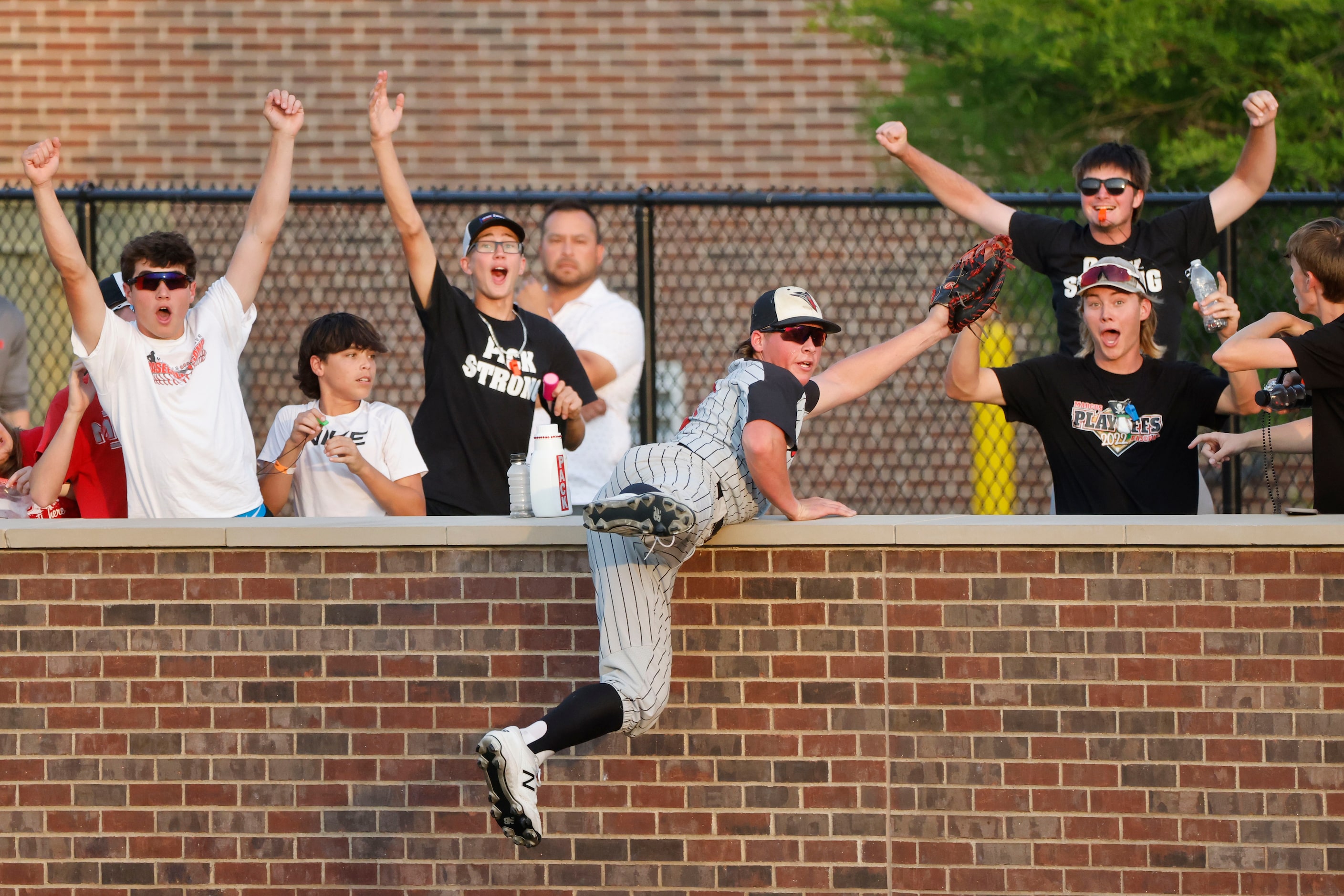 Flower Mound Marcus player Jacob Martin reacts after making a catch on a foul ball against...