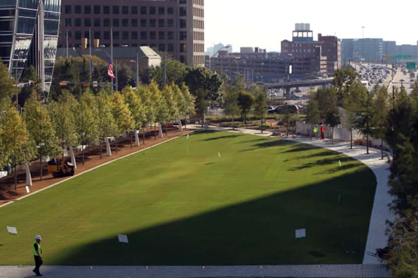 It's quite a contrast: A green lawn and trees in the Klyde Warren Park sit above the bustle...