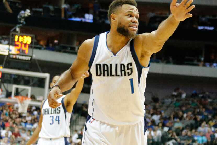 Dallas Mavericks guard Justin Anderson (1) tries to assist an official with a possession...