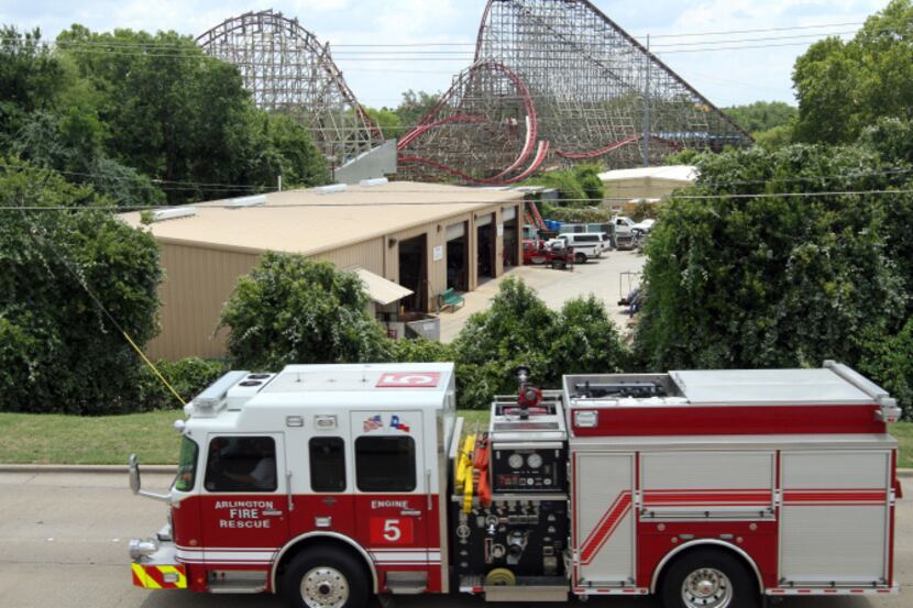 An Arlington firetruck remained parked just beyond a backstage area and the Texas Giant at...