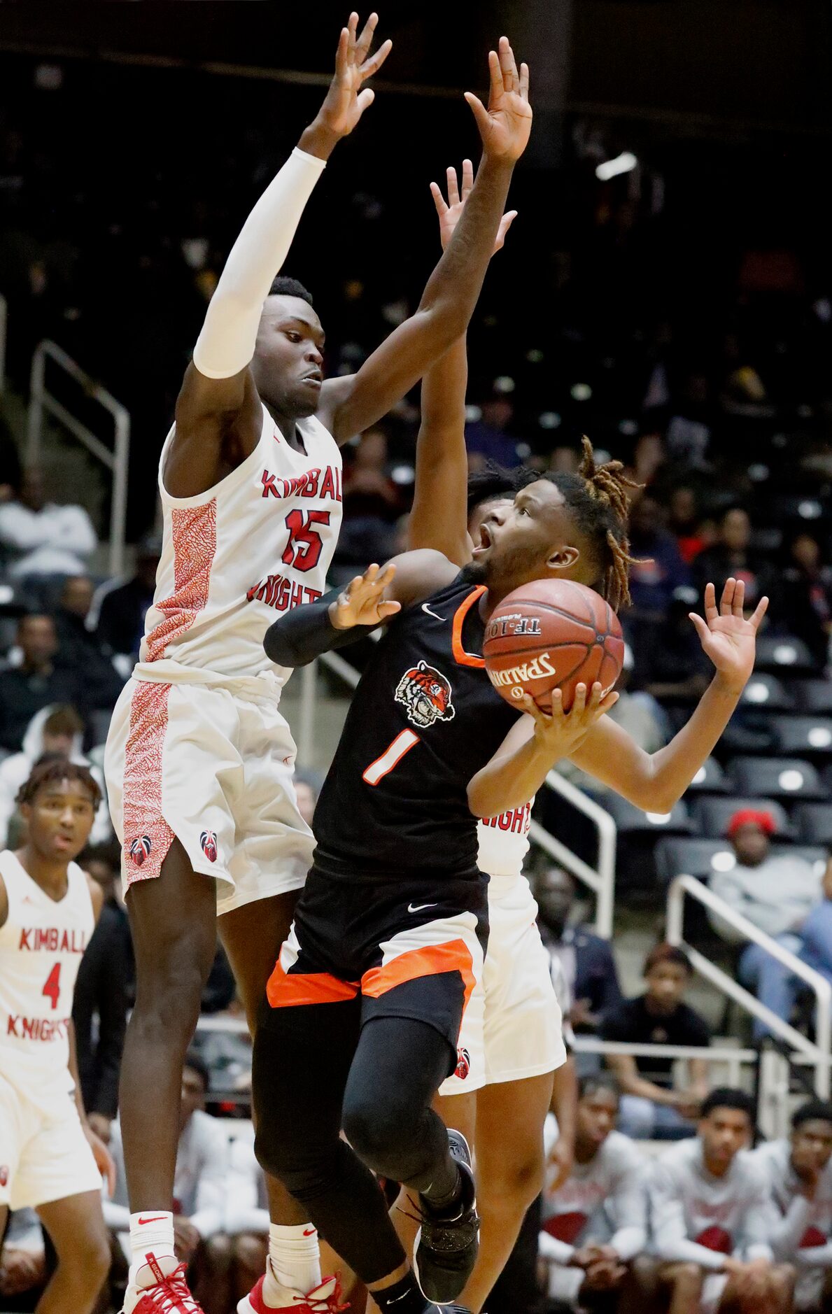 Kimball High School forward Kyron Henderson (15) attempts to block the shot attempt by...