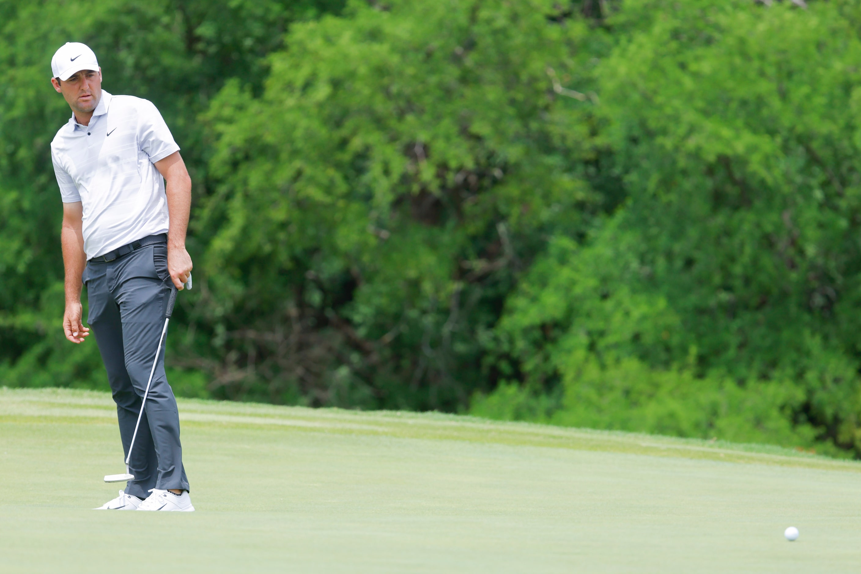 Scottie Scheffler of United States watches as he putts on the ninth hole during the second...