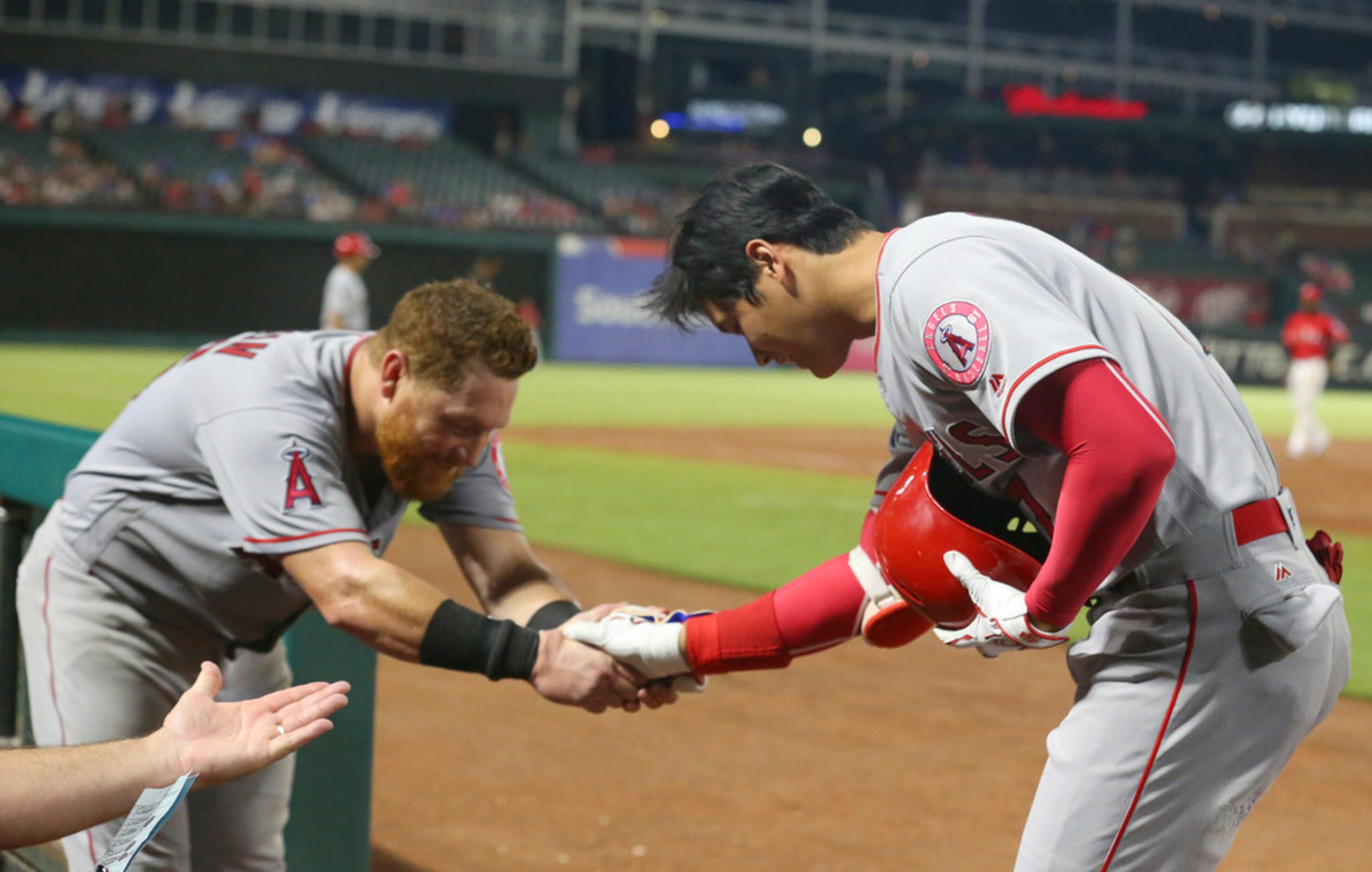 Los Angeles Angels' Kole Calhoun, left, bows to pinch-hitter Shohei Ohtani (17) after...