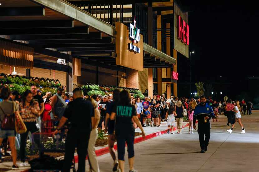 People waited outside a new H-E-B store in Frisco when it opened in September.