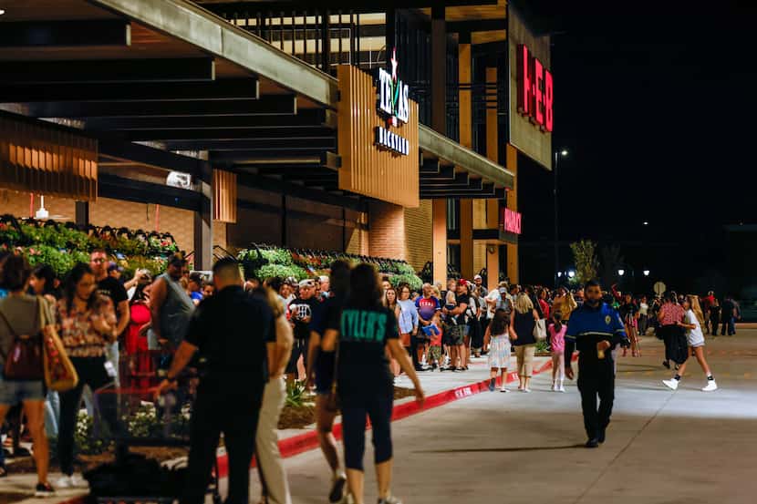 People wait outside the new H-E-B store set to open at 6AM in Frisco on Wednesday, Sept. 21,...