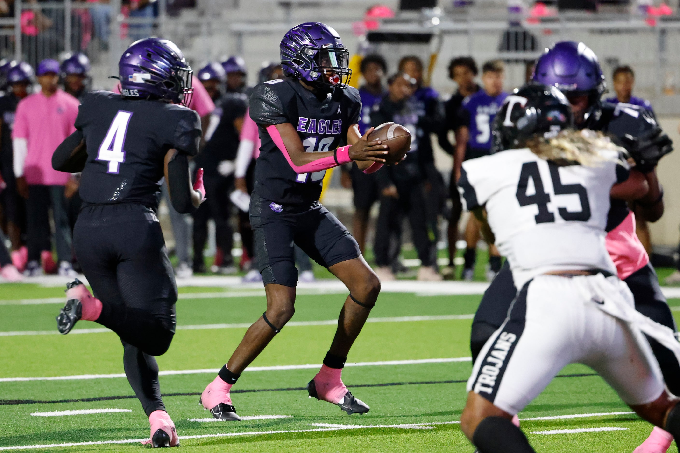 Crowley High’s Caleb Williams (center) hands the ball against Trinity High during the first...