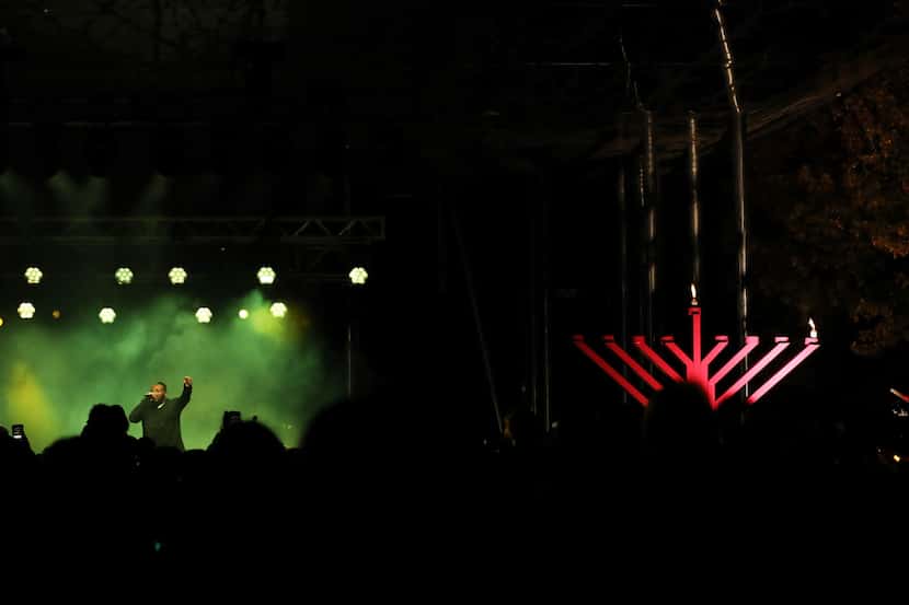 Israeli rapper Nissim Black performs after the lighting of the first flame on the giant pink...