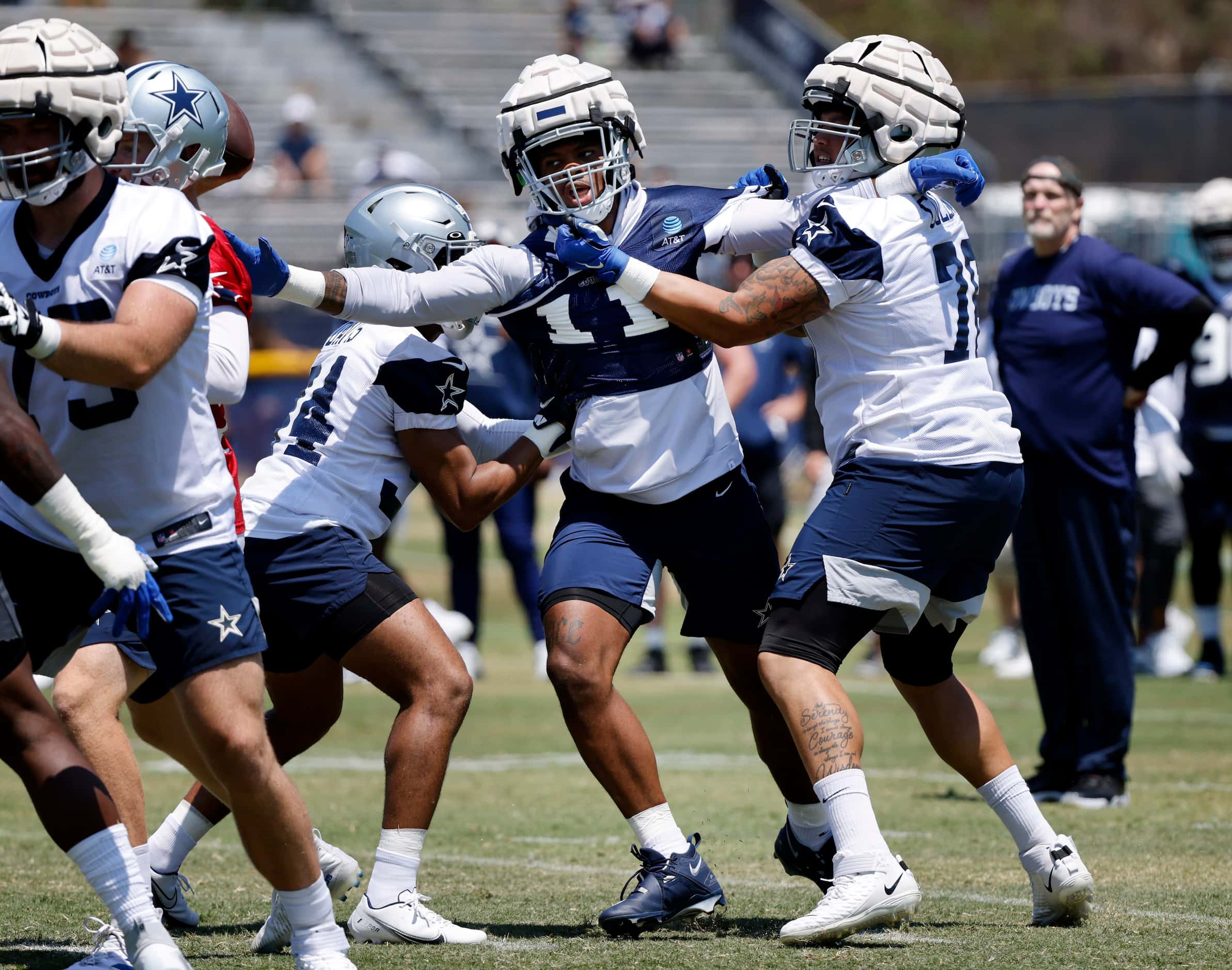 Dallas Cowboys outside linebacker Micah Parsons (11) fights off offensive lineman as he...