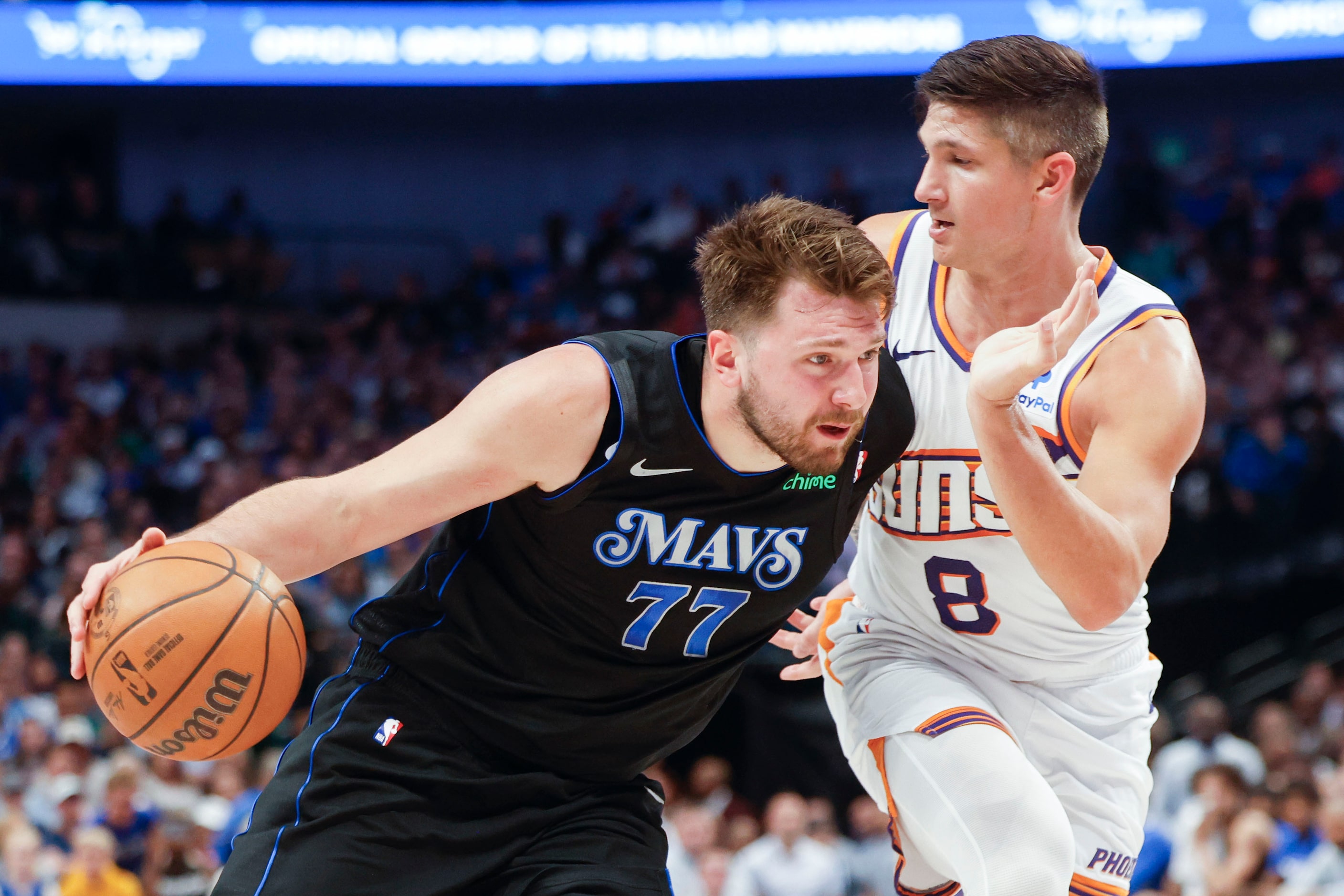 Dallas Mavericks guard Luka Doncic (77) dribbles against Phoenix Suns guard Grayson Allen...