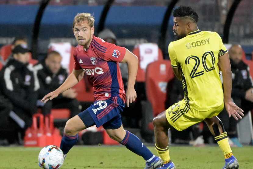 FC Dallas midfielder Paxton Pomykal (19) move the ball around Nashville SC midfielder Anibal...