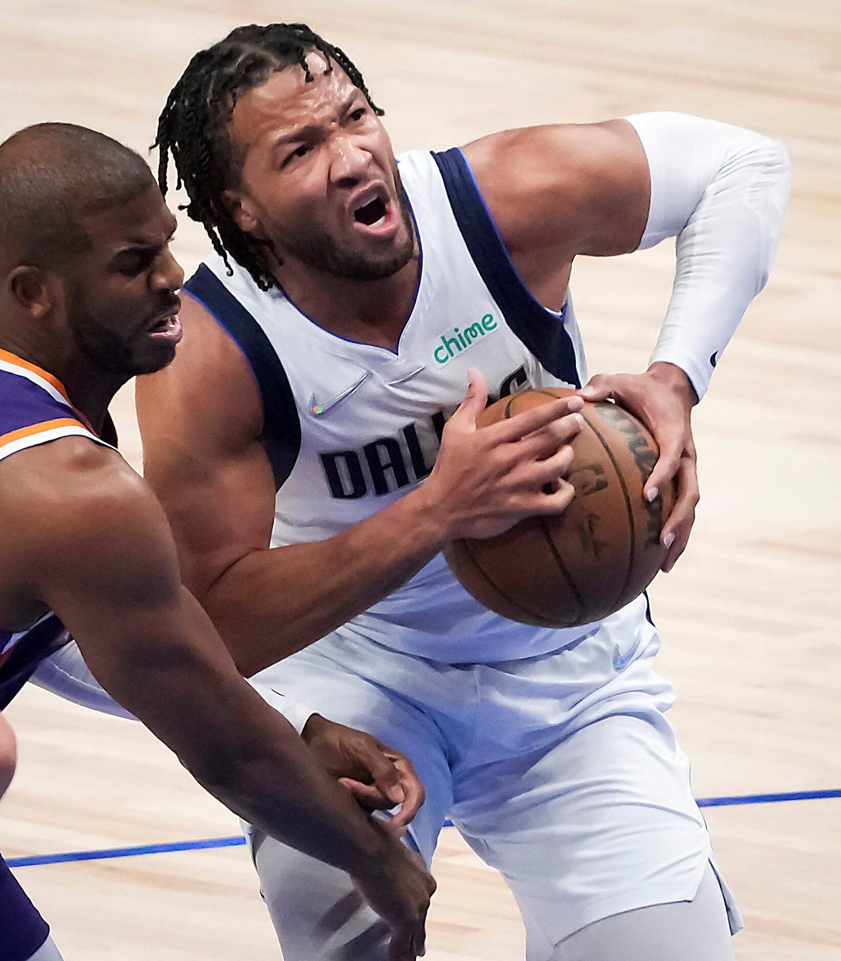 Dallas Mavericks guard Jalen Brunson (13) is fouled by Phoenix Suns guard Chris Paul (3)...