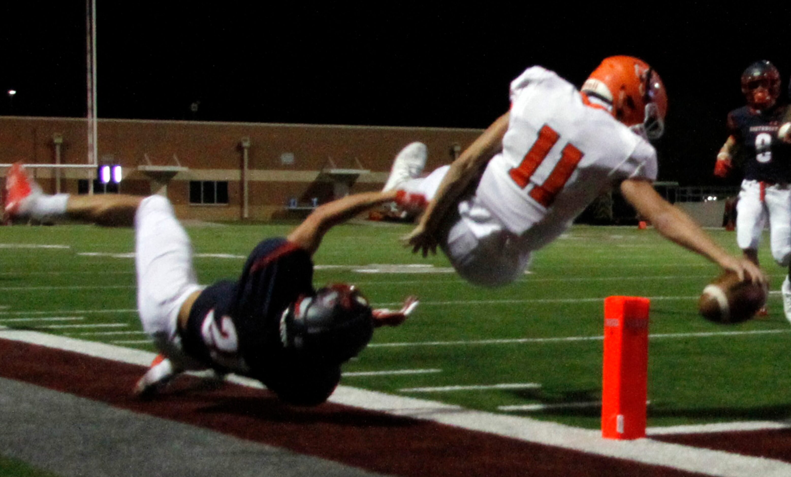 McKinney North quarterback Hayden Richardson (11) reaches to extend the ball inside the...