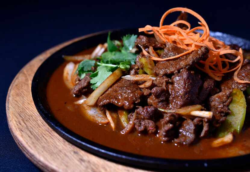 Cumin lamb with onions, bell peppers seasoned with soy sauce and cumin, from Royal China in...