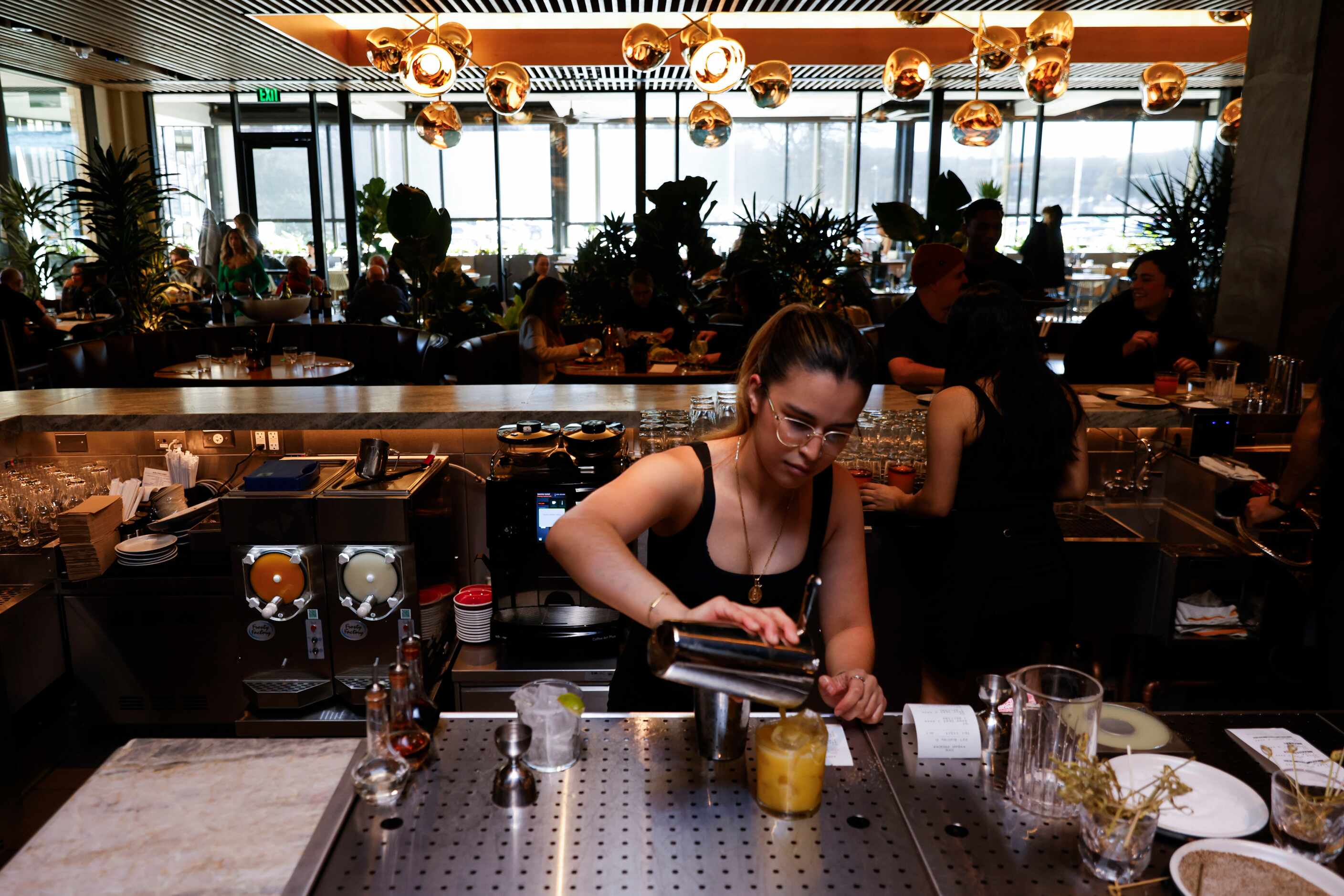 Bartender Jhuliana Martinez pours a drink at Joey Dallas during a preview shift on Jan. 16,...
