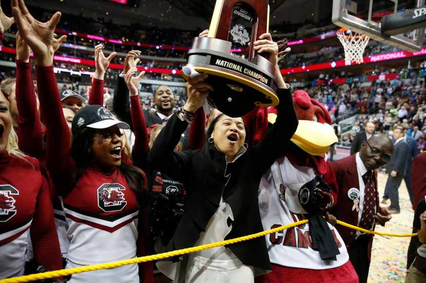 South Carolina Gamecocks head coach Dawn Staley celebrates with the cheerleaders and mascot...