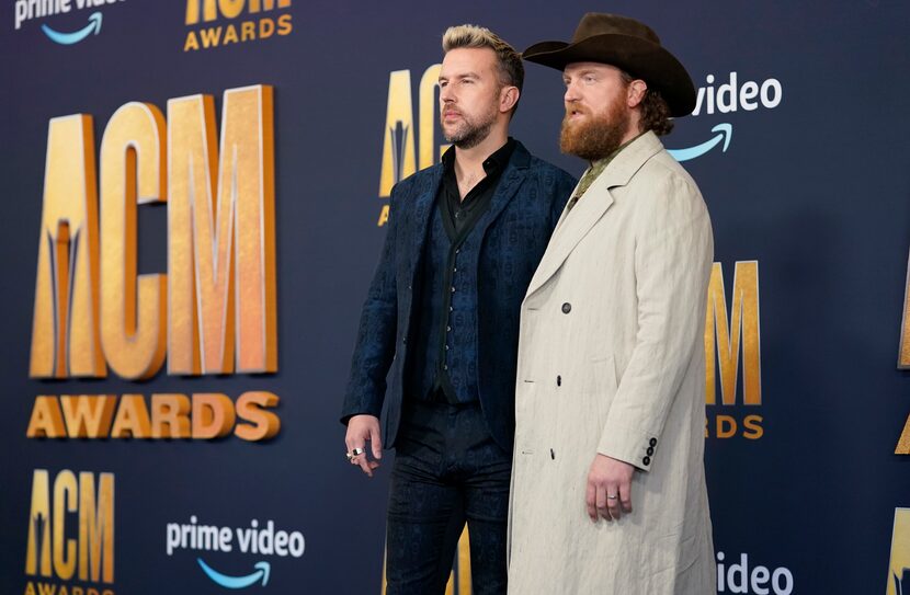 T.J. Osborne, left, and John Osborne of the Osborne Brothers arrive at the 2022 Academy of...