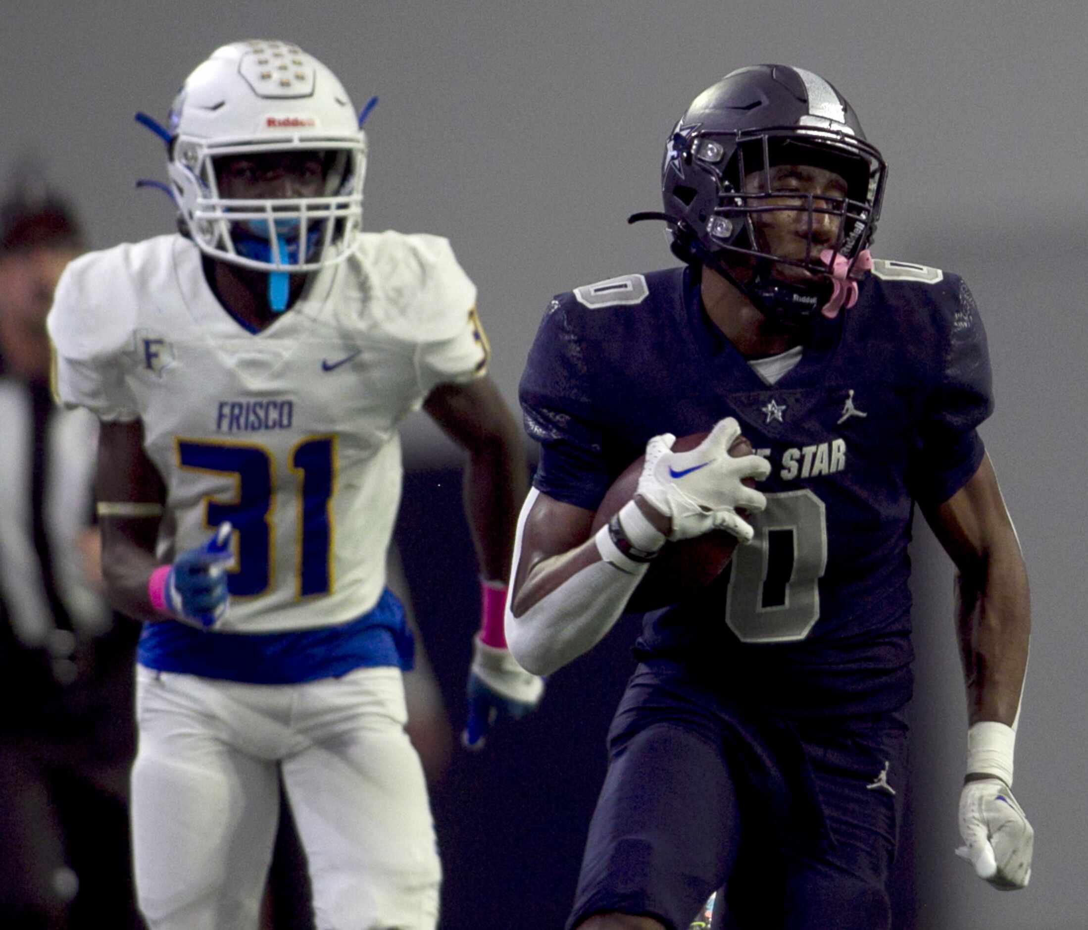 Frisco Lone Star's Davian Groce (0), right, makes a long kickoff return as Frisco defender...