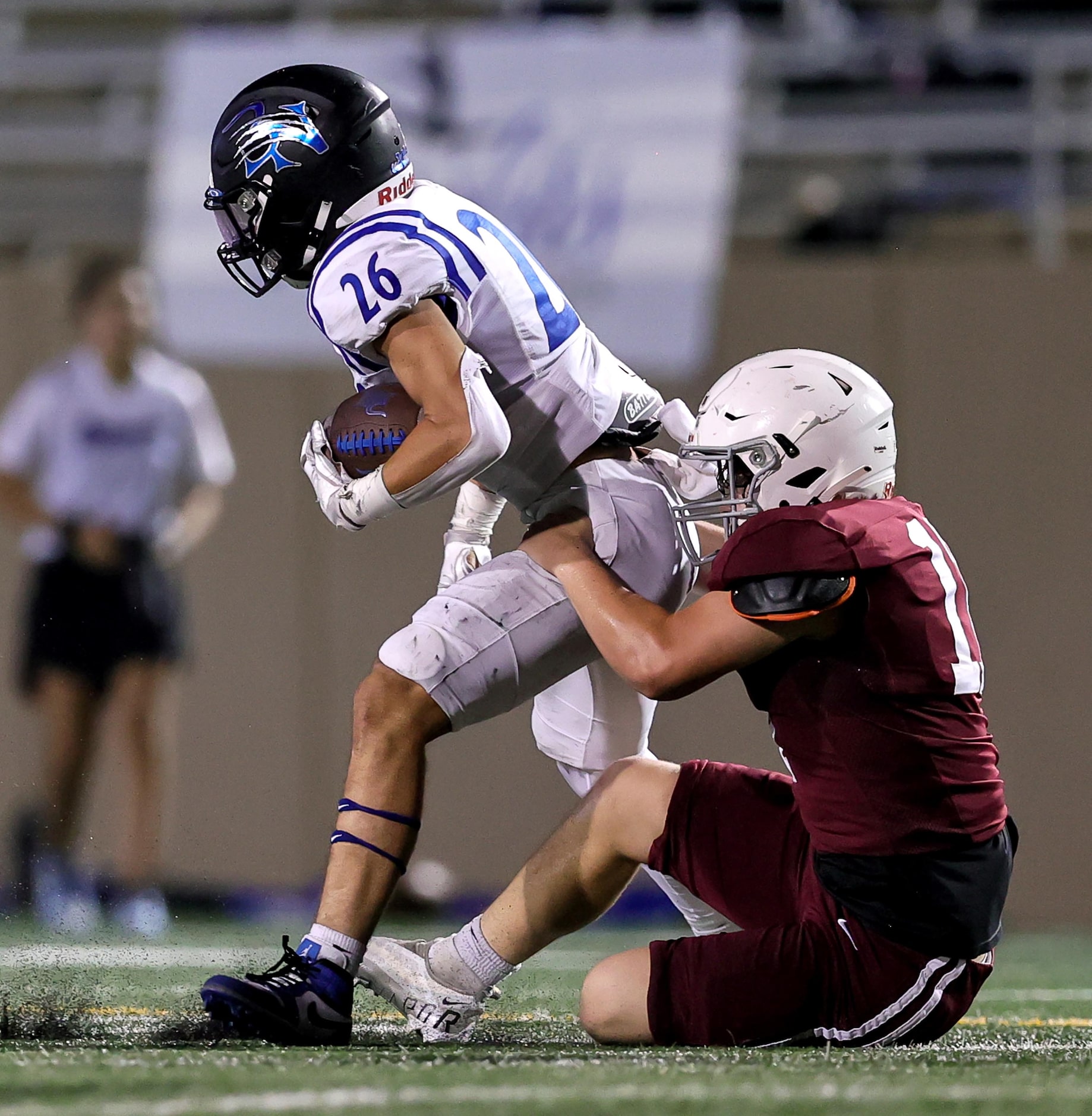 Byron Nelson running back Tucker James (26) gets dragged down by Plano linebacker Grant...