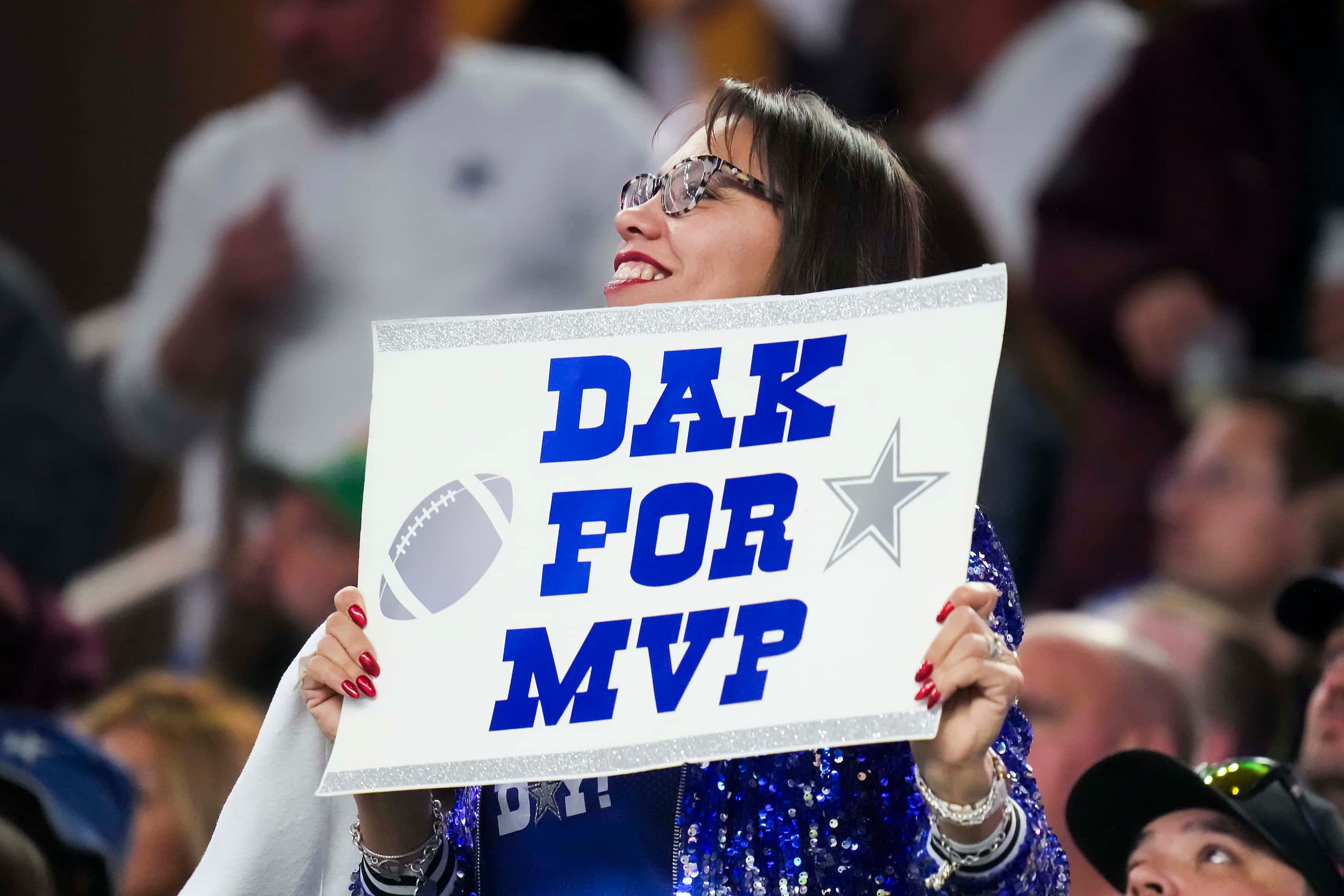 A fan cheers for Dallas Cowboys quarterback Dak Prescott during the first half of an NFL...