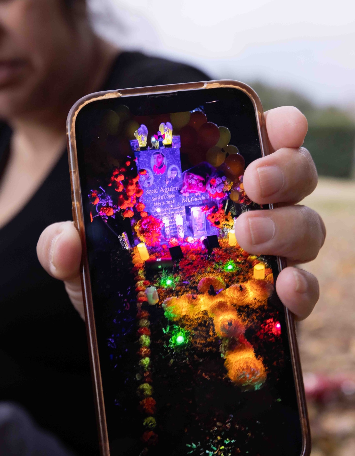 Ana Aguirre shows how she decorated her son Isaac Aguirre’s gravesite for Día de los Muertos...