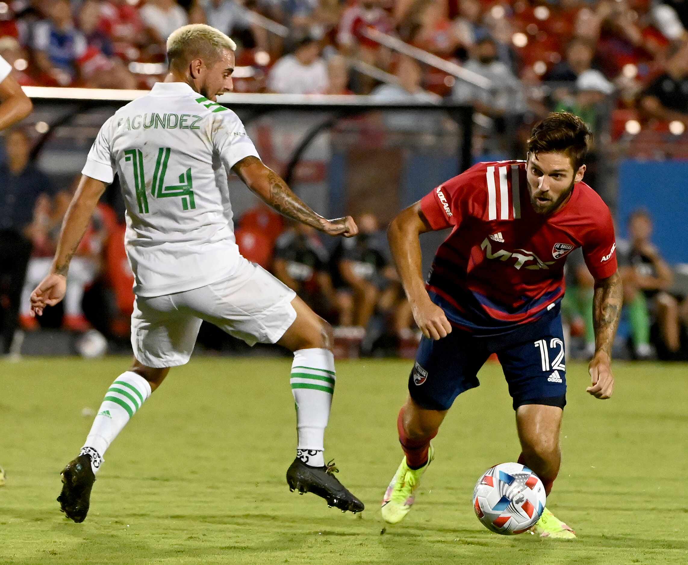 FC Dallas midfielder Ryan Hollingshead (12) moves the ball around Austin FC forward Diego...