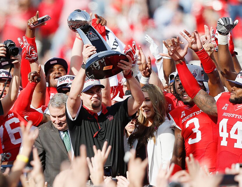 HOUSTON, TX - DECEMBER 05: Head coach Tom Herman of the Houston Cougars raises the AAC...