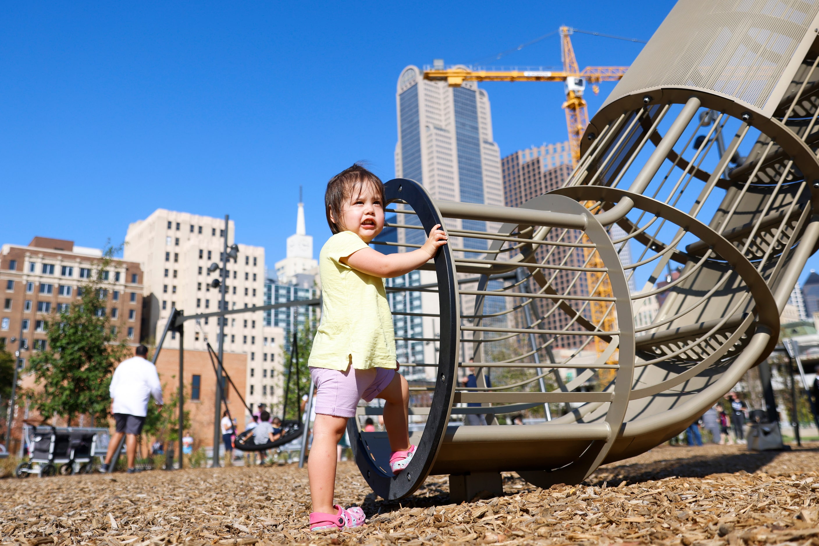 Camryn H., 2, looks away as she attempts to climb up the  mammoth play structure during the...