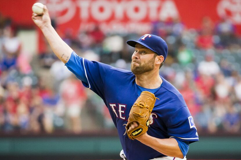 Texas Rangers starting pitcher Colby Lewis pitches during the third inning against the Los...