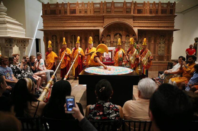 Tibetan Buddhist Monks from the Drepung Loseling Monastery conduct a  ceremony to dismantle...