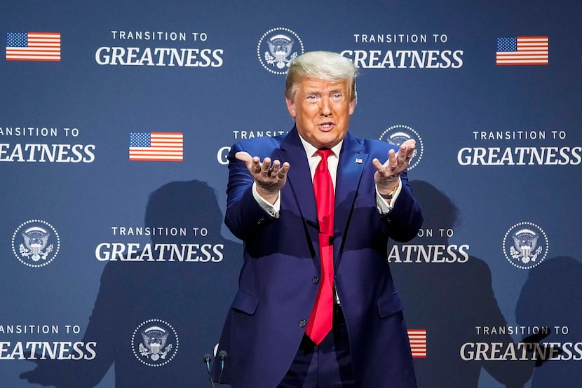 President Donald Trump motions to the audience as he participates in a roundtable...