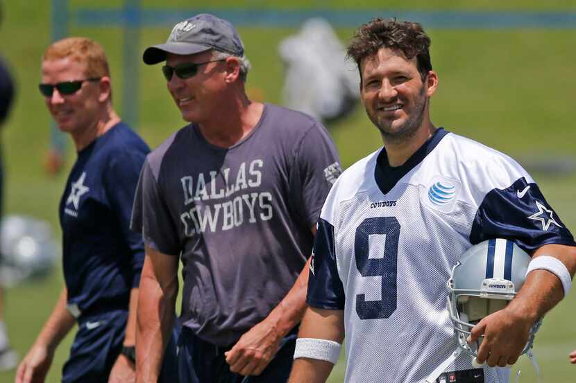 Dallas Cowboys quarterback Tony Romo (9) is pictured with head coach Jason Garrett, left,...