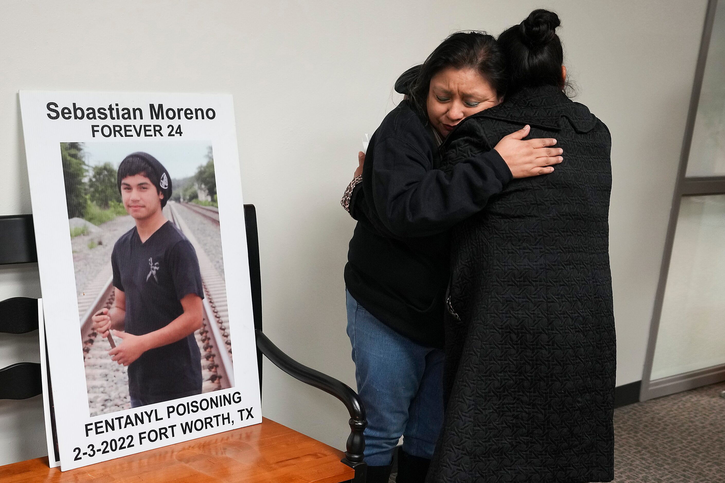 Ofie Moreno (center), a parent who lost a child to fentanyl poisoning, hugged Yolanda...