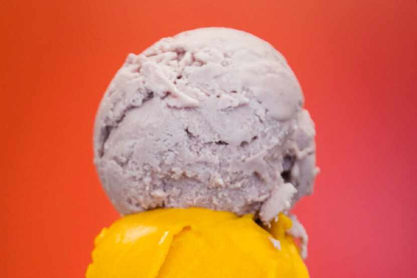 A scoop of ube, a purple yam, sits on top of a scoop of mango sorbet at Betty Ringer Ice...