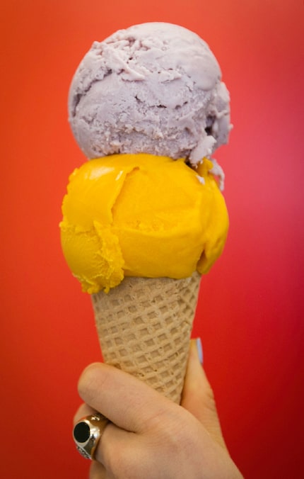 A scoop of ube, a purple yam, sits on top of a scoop of mango sorbet at Betty Ringer Ice...