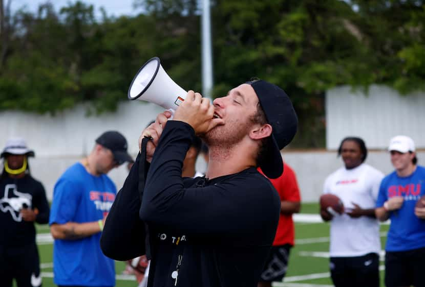 SMU quarterback Preston Stone uses a bullhorn to give instruction to kids participating in...