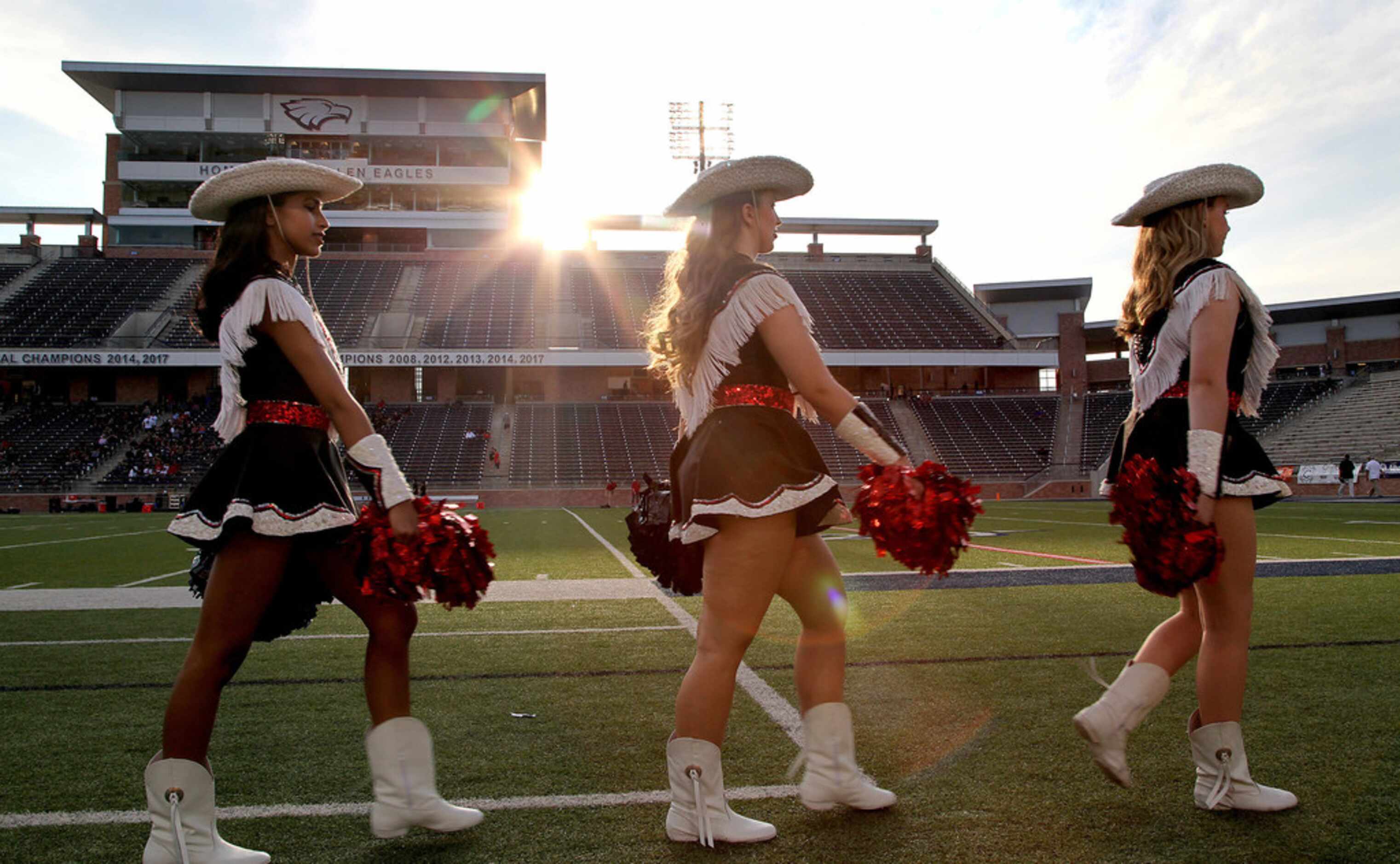 The Lovejoy High School Majestics drill team march the sideline before kickoff as...