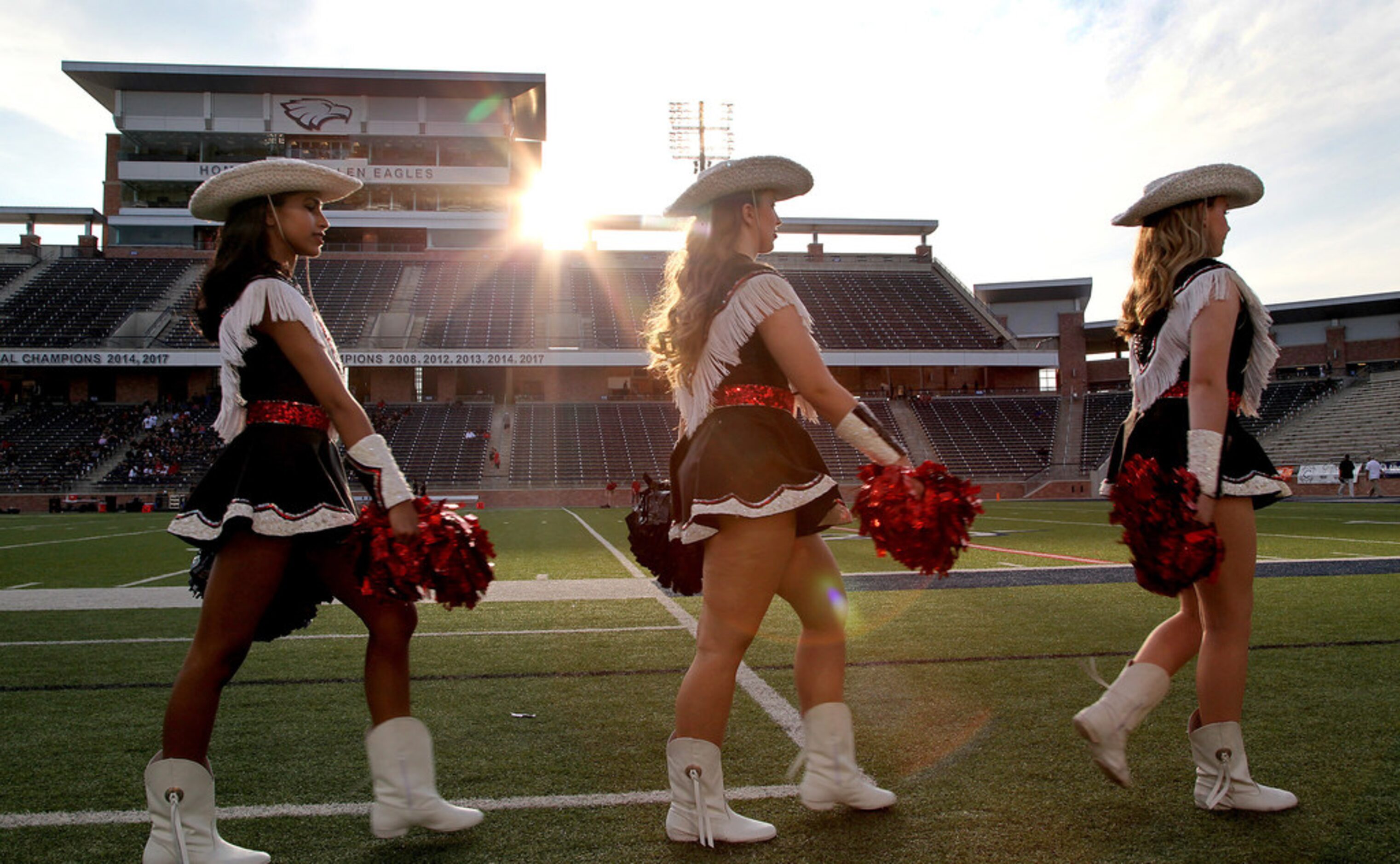 The Lovejoy High School Majestics drill team march the sideline before kickoff as...