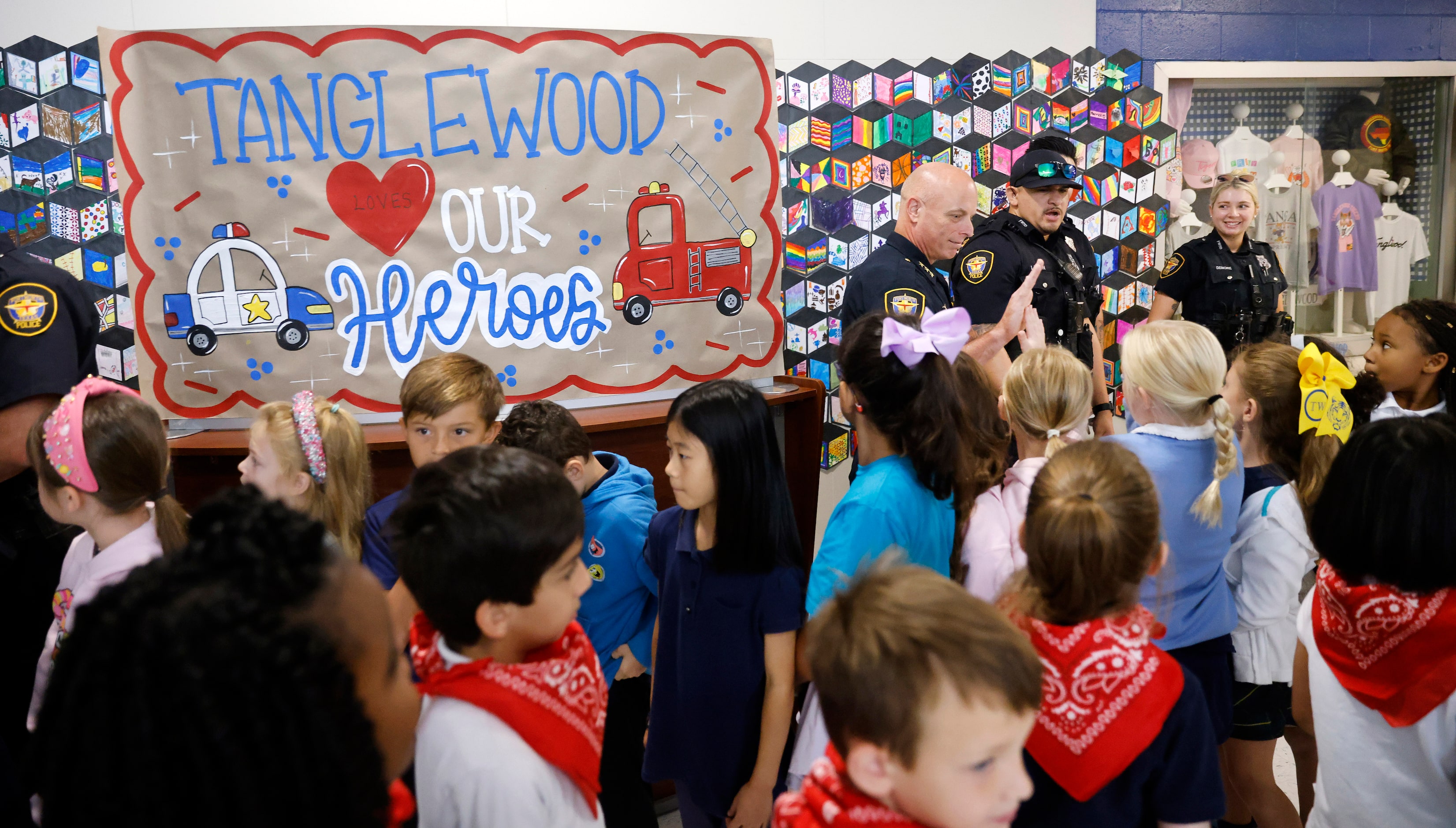 Fort Worth Police Assistant Chief Robert Alldredge (center, left) slaps hands with  second...