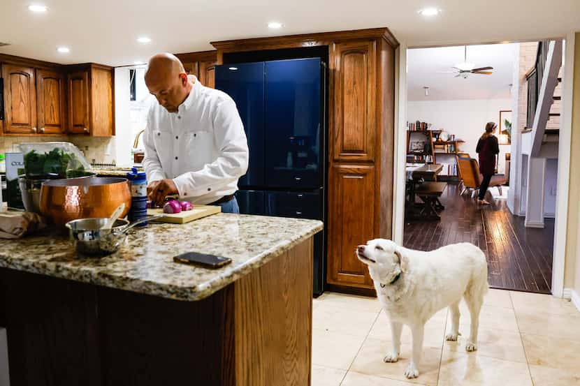 Mike Gibson, who works as a private chef and estate manager, prepares dinner for his family...