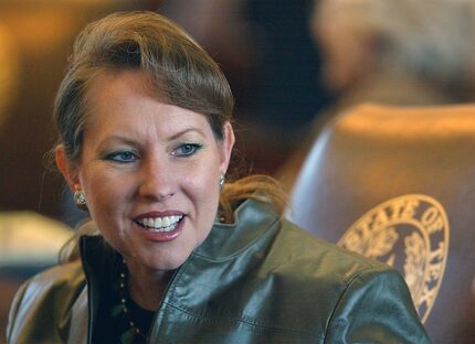 Suzanna Hupp responds to a colleague before a floor session in the Texas House of...