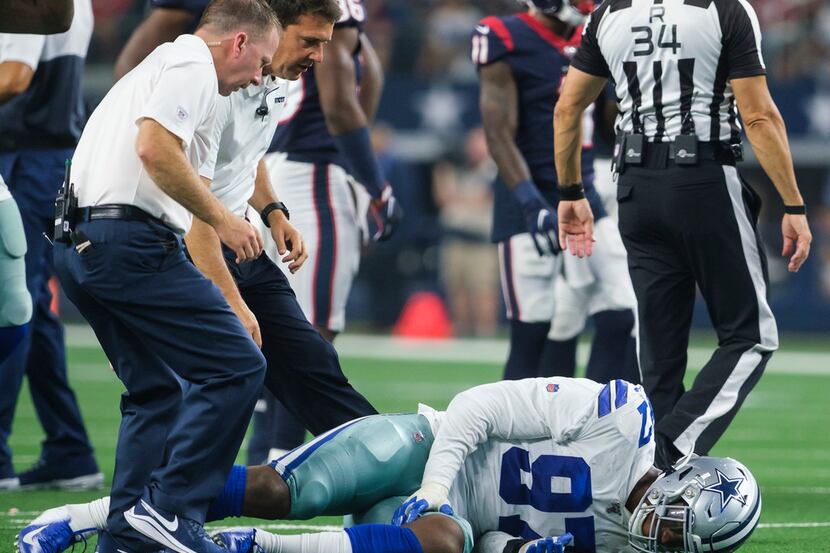 Dallas Cowboys defensive end Taco Charlton (97) grabs his leg after being injured during the...