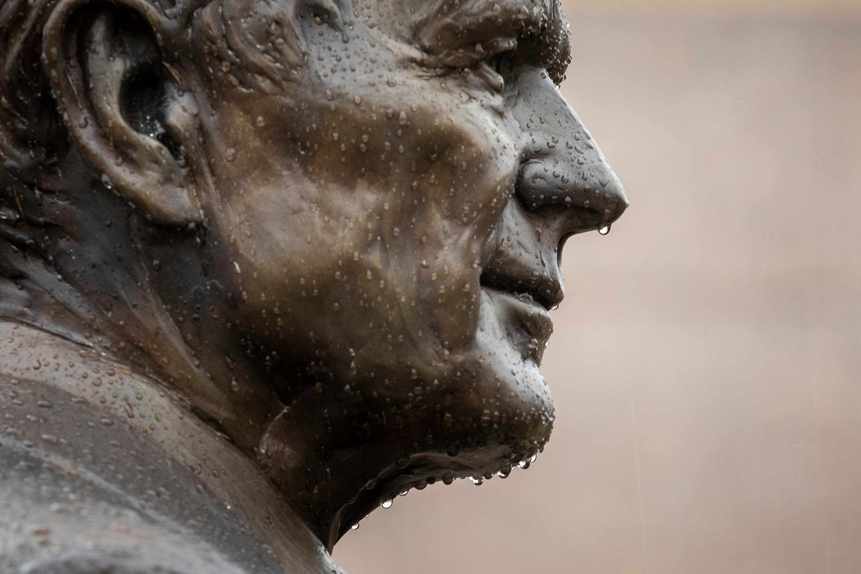 Raindrops collect on a statue of George H.W. Bush outside the George Bush Presidential...